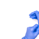 hands putting on disposable gloves for protection