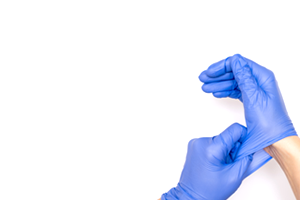 hands putting on disposable gloves for protection