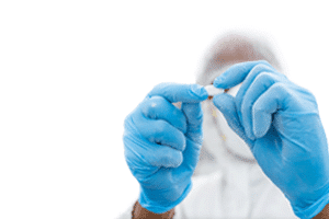 Manufacturing technician inspecting a pill