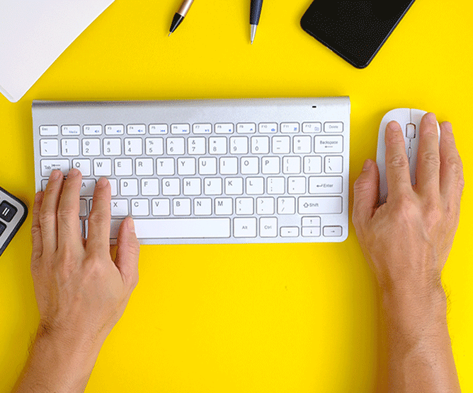 work table with hands on modern keyboard