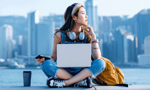 woman on laptop in front of skyline
