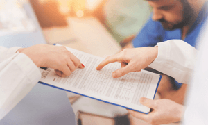 healthcare professional holding clipboard