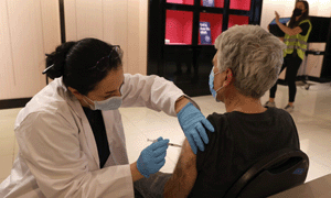woman administering vaccine